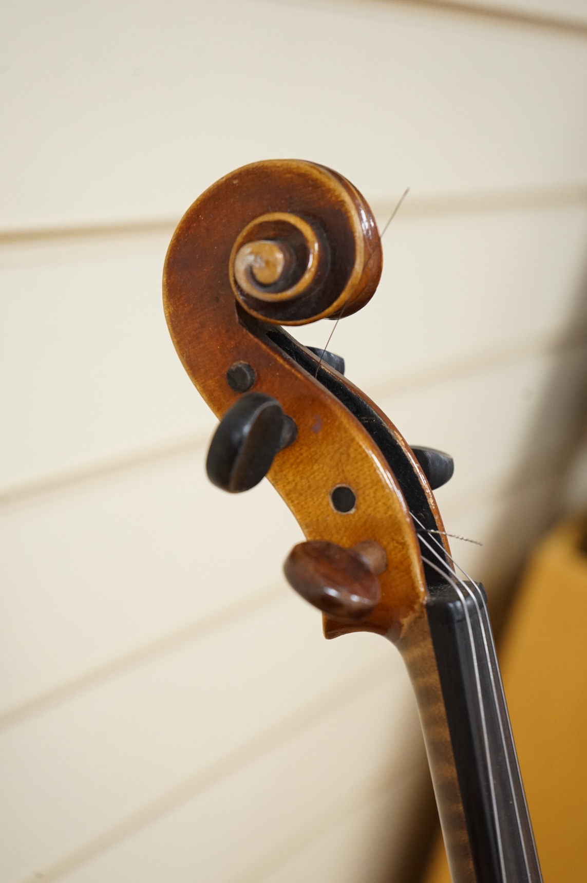 Five cased 20th century violins, including; a German violin, two Czech violins, a three-quarter size violin with a label for Bienfait, and a Romanian quarter size violin, all in cases or the remains of cases.